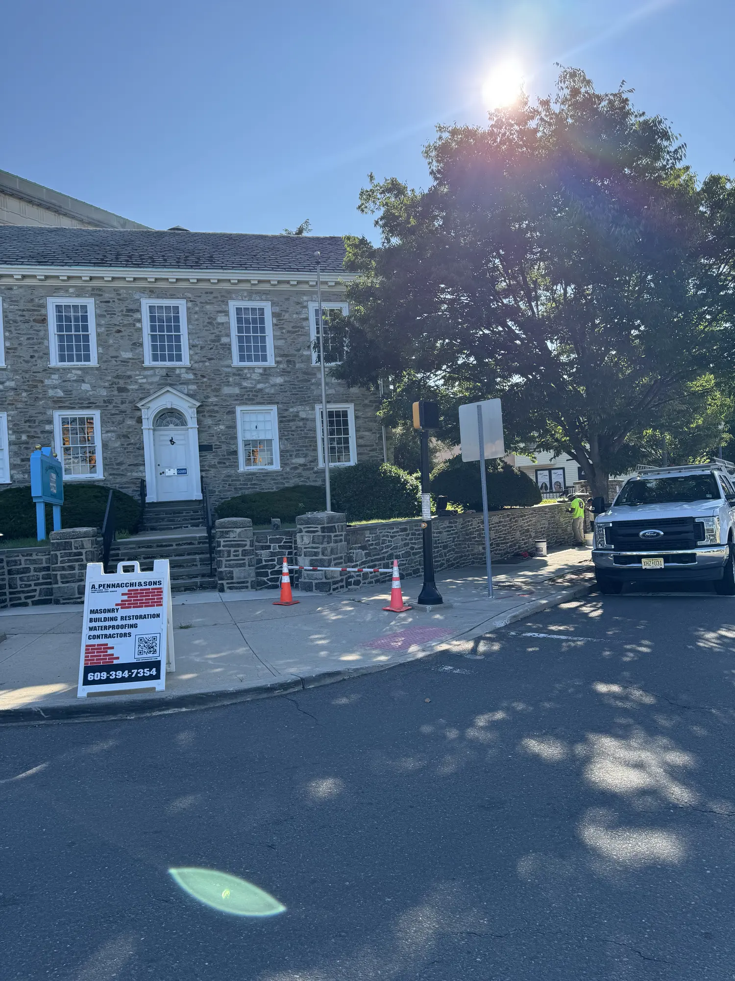 A. Pennacchi & Sons crew restoring the historic fieldstone retaining wall at a landmark stone building in New Jersey