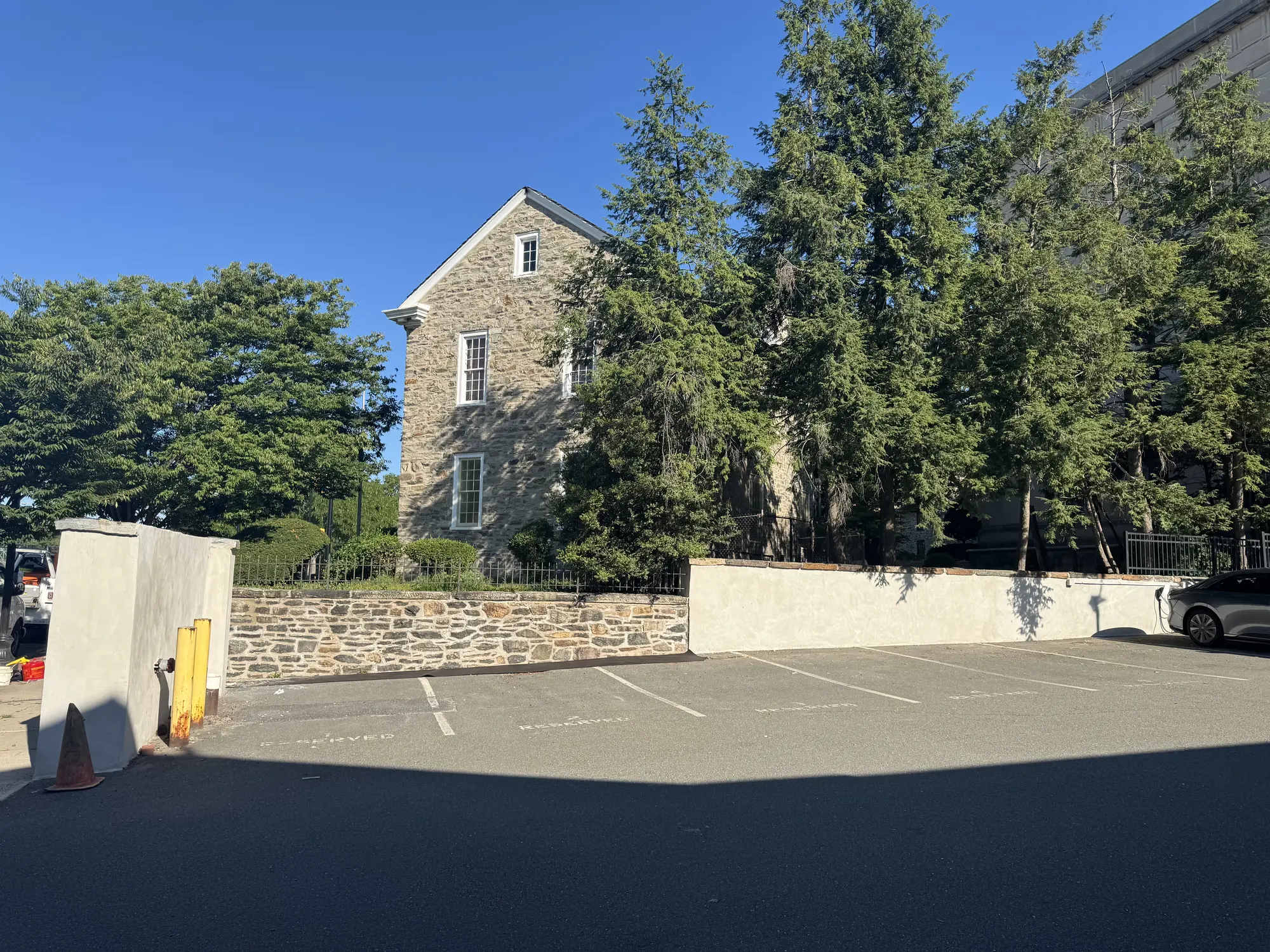 Restored fieldstone retaining wall and repointed stone facade at a historic landmark building in New Jersey