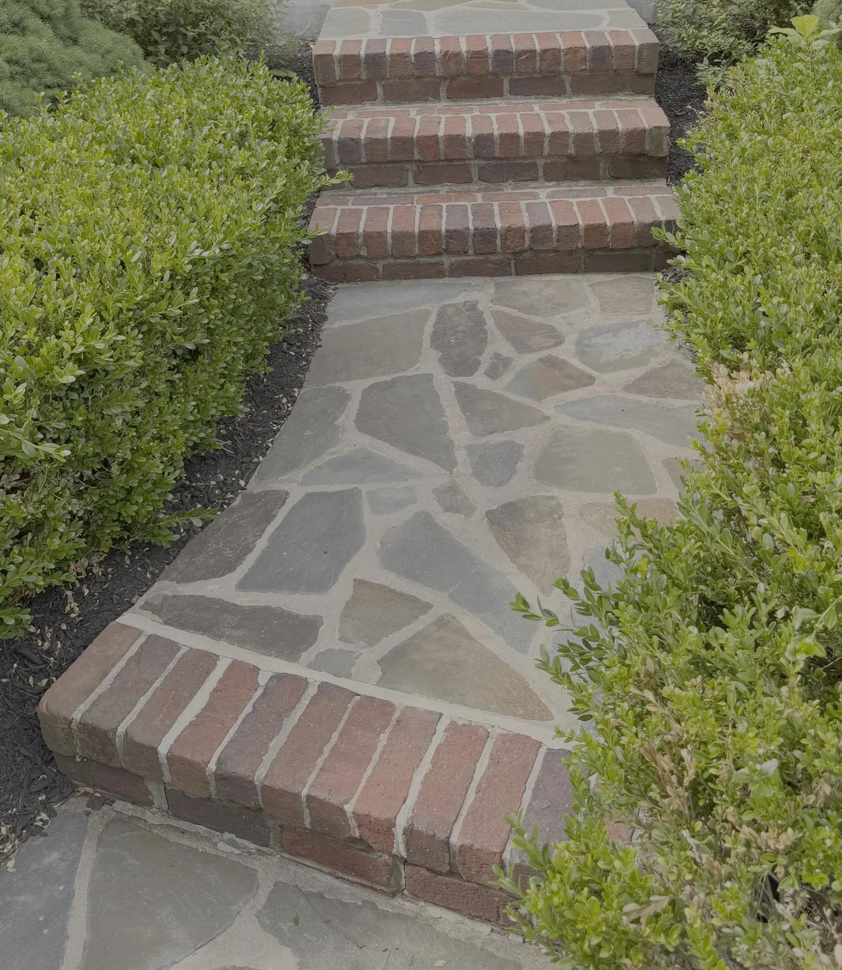 Worn brick entrance steps before Pennacchi restoration in New Jersey