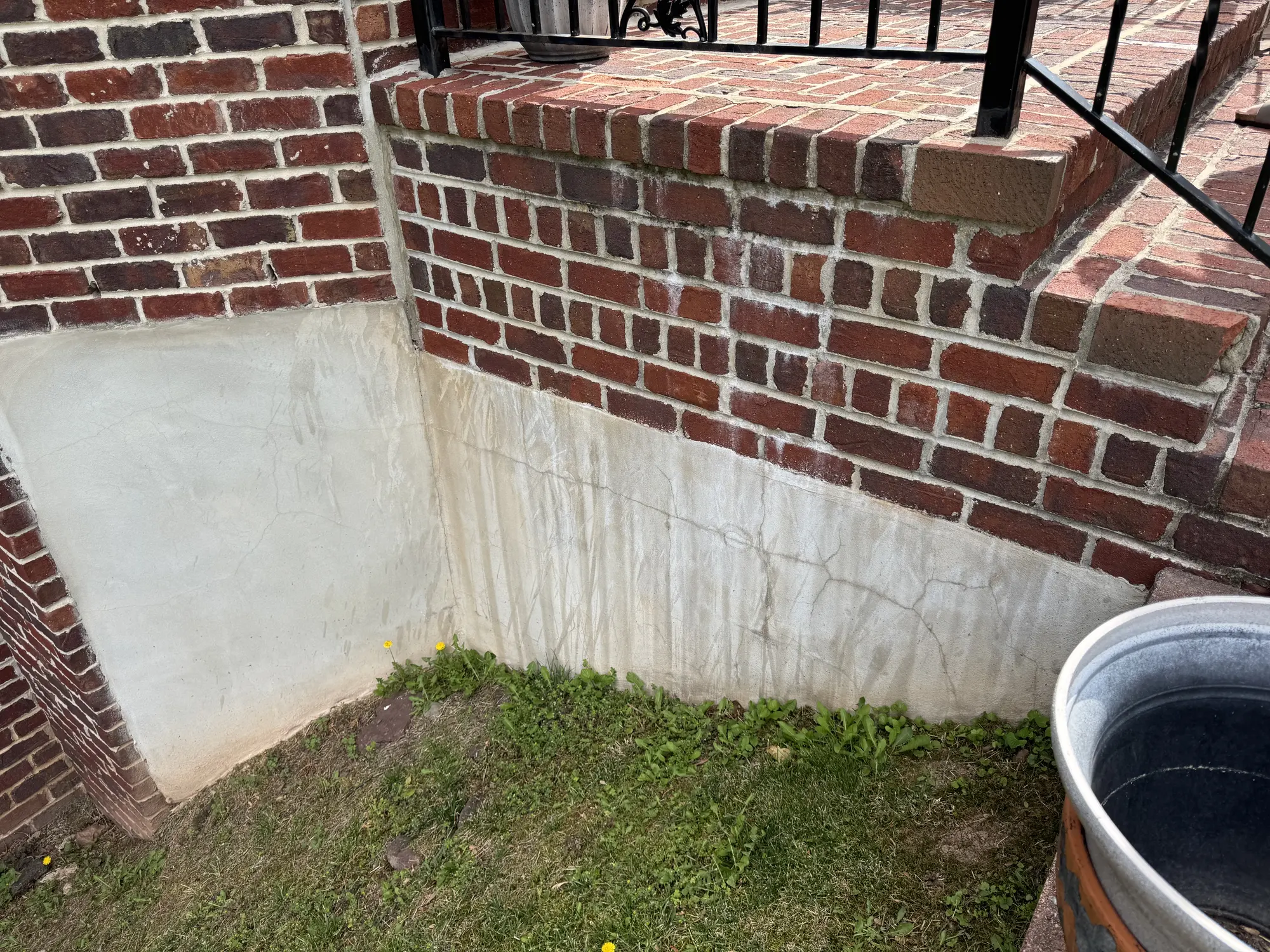 Stained exterior stucco wall before Pennacchi restoration in New Jersey